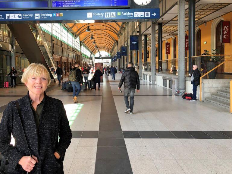 Dressed in a comfortable shirt, jacket, and slacks outfit Catherine Sweeney is ready to board the train at Wroclaw, Poland's railway station