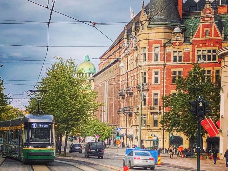 Tram on a busy city street in Helsinki, Finland