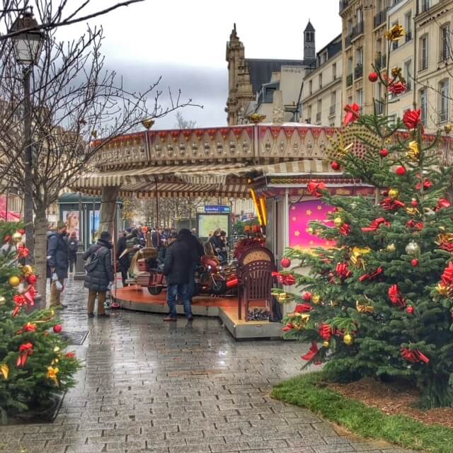 Christmas carousel and decorations on rue de Rivoli, Paris, France