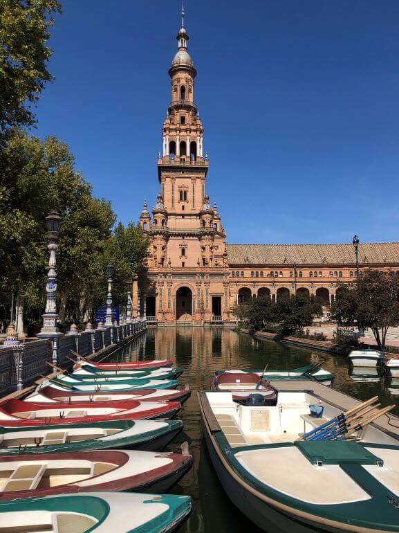 Row boats on the small canal that runs along the interior of Plaza de España, Seville, Spain
