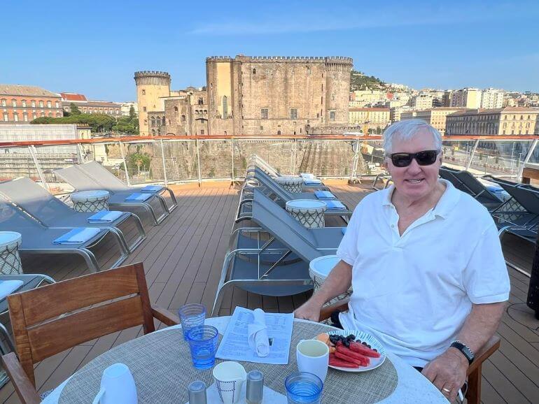 Mr. TWS at breakfast on the Aquavit Terrace of the Viking Sea while at port in Naples, Italy