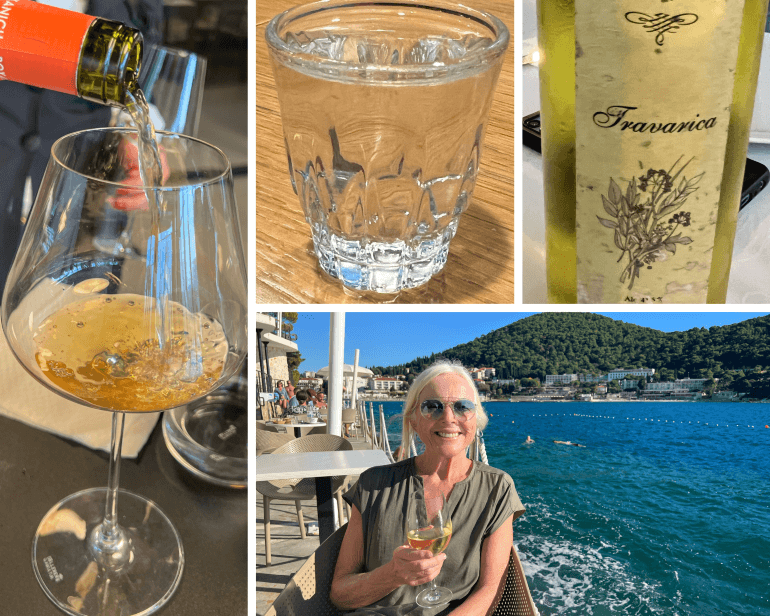 Wine and spirits of Croatia -- Roxanich amber-hued wine called “Lara”, plum rakija, Travarica bottle, Sweeney with a glass of Pošip in Dubrovnik, Croatia