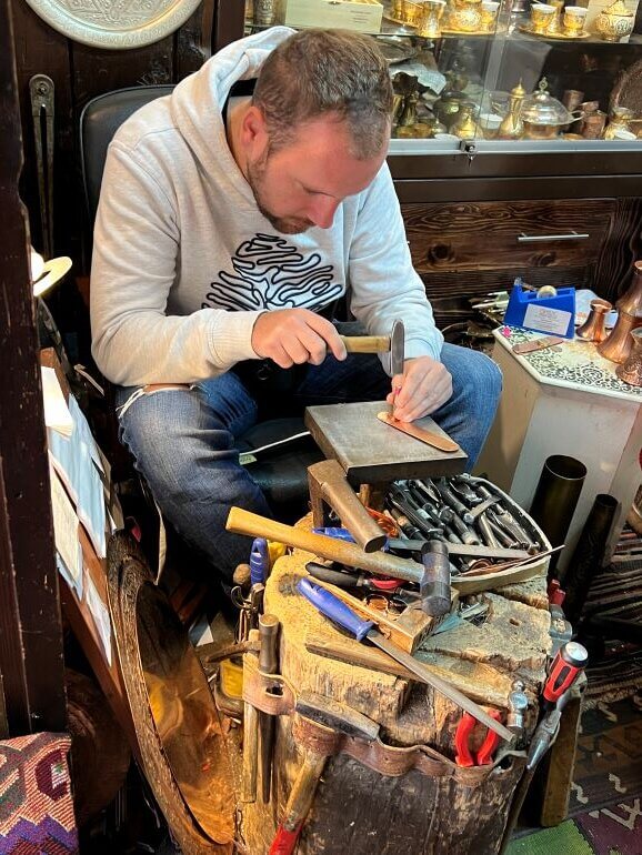 Coppersmith at work in his shop in the old city of Sarajevo, Bosnia