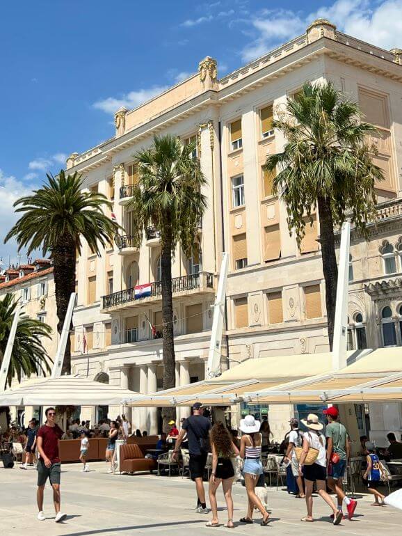 Palm trees and market stalls along the Riva Promenade in Split, Croatia