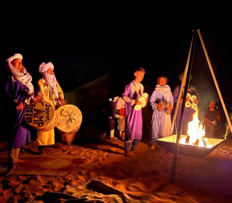 Berber music entertainment around the bonfire at a desert luxury camp in the Sahara Desert