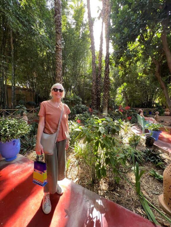 Catherine Sweeney with souvenir purchase in hand at Jardin Majorelle and Berber Museum in Marrakech, Morocco