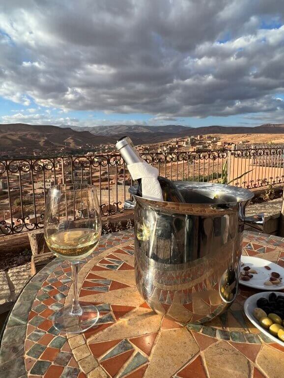 Wine on the pool terrace of Hotel Xaluca Dades overlooking the valley and city of Boumalne du Dades. Morocco