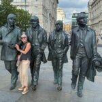 Catherine Sweeney at the Beatles statues in Liverpool, England