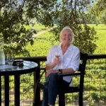 Catherine Sweeney sitting outside on a summer day at Wilson Winery in Healdsburg, California