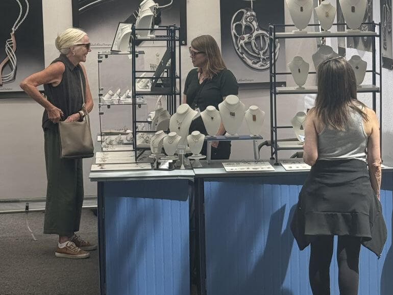 Buying hand-crafted jewelry at Elizabeth Kline Designs booth in Old Town Chicago, Illinois
